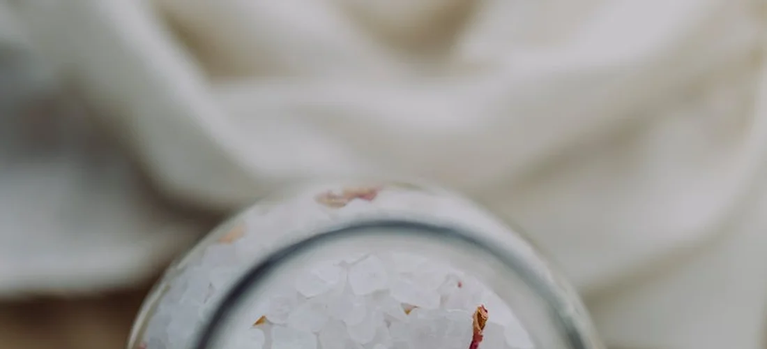 Close-up image of Epsom salt crystals in a small container