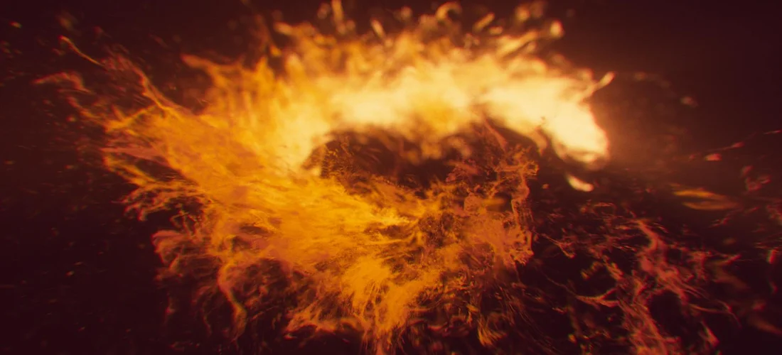 Abstract close-up of swirling orange flames against a dark background.