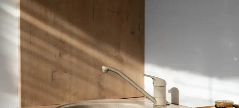 Close-up of a wooden cabinet panel with a faucet in a hot tub area