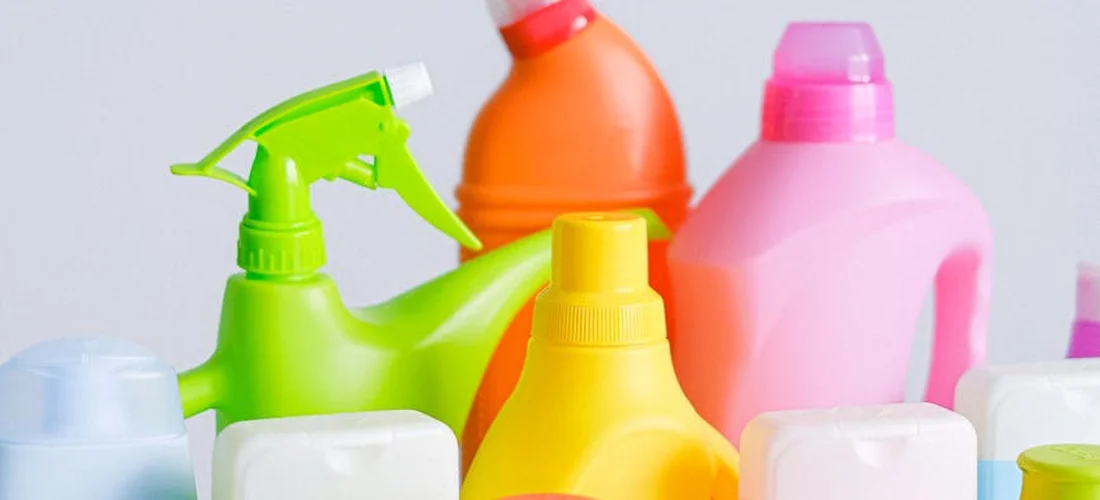A collection of colorful plastic bottles and containers used for spa chemicals, arranged together