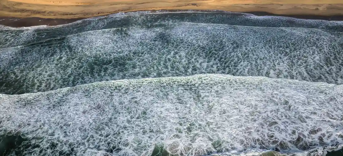 Cloudy hot tub water with foamy bubbles on the surface.
