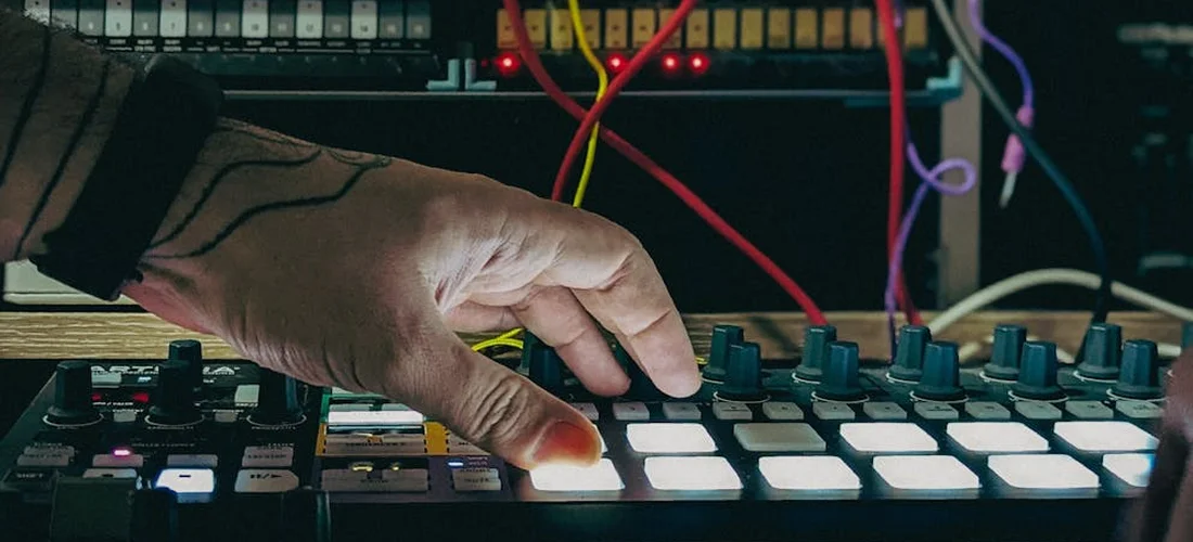 Close-up of a technician's hand adjusting a hot tub control panel with illuminated buttons and exposed circuit board