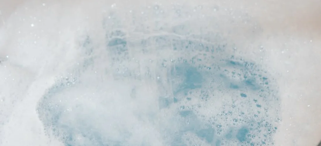 Close-up of a bubbling hot tub with white foam