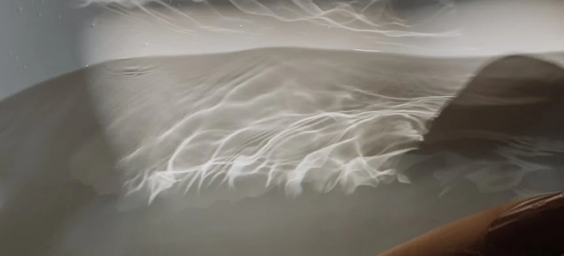 Close-up of a hot tub with swirling water and steam, illustrating signs of a worn filter.