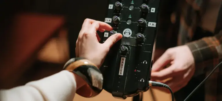 Close-up of a hand adjusting a hot tub control panel with multiple buttons and dials