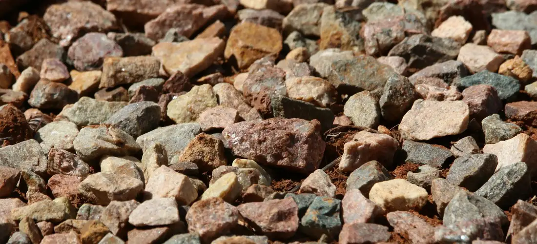 Close-up of coarse gravel and small stones on the ground