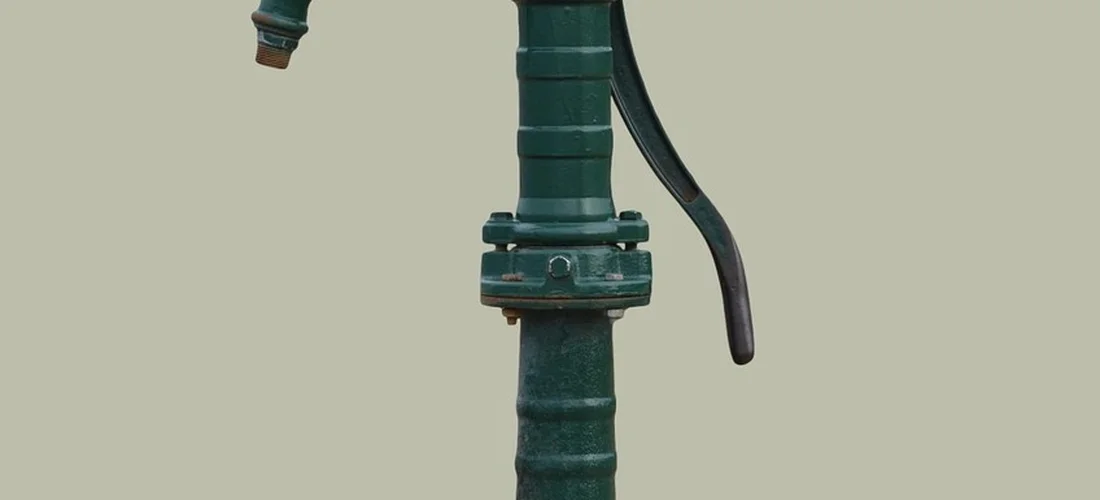 Close-up of a green hot tub plumbing pipe with a valve and a loose hose, suggesting installation-related vibration.
