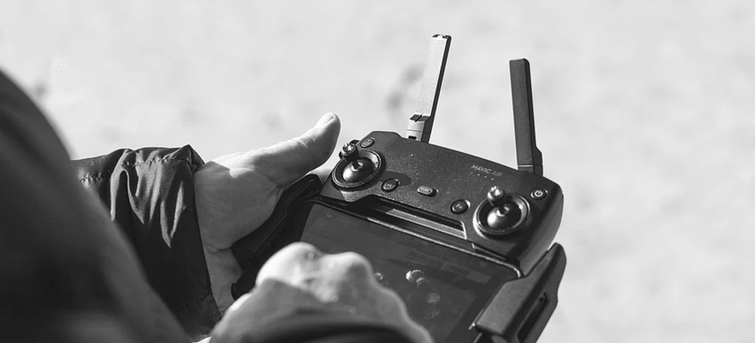 Close-up of a handheld remote control with antennas extending upward.