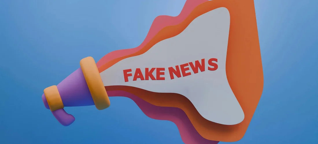 Stylized megaphone with the words 'FAKE NEWS' on its bell, set against a blue background.