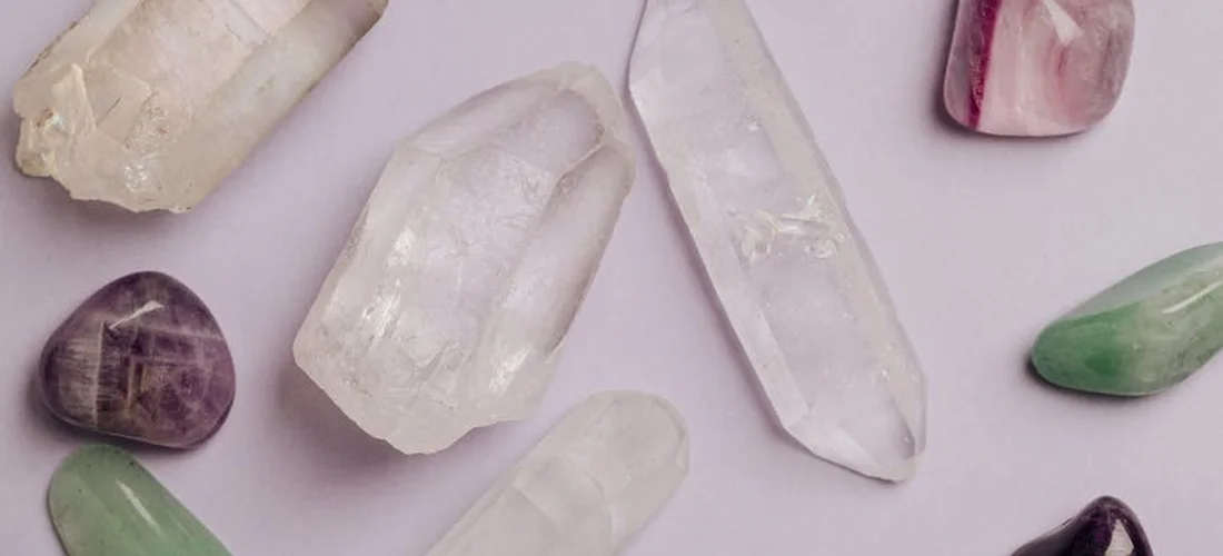 Assorted mineral crystals on a soft lavender background, representing mineral-based pool sanitizers.